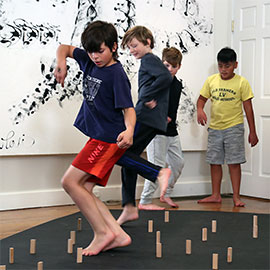 kid standing on blocks